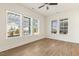 Bright bonus room featuring hardwood floors and many windows at 244 Bevis Marks Dr, Fuquay Varina, NC 27526