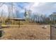 A fenced community dog park with shade features and agility structures on a wood chip surface at 244 Bevis Marks Dr, Fuquay Varina, NC 27526