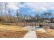 Fenced community dog park with agility features and shade structures accessible via a concrete path at 244 Bevis Marks Dr, Fuquay Varina, NC 27526