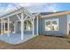 Exterior view of the home highlighting the stone patio, pergola, and well-manicured lawn at 244 Bevis Marks Dr, Fuquay Varina, NC 27526