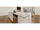Modern kitchen with a granite island, seating, stainless steel dishwasher, and easy access to the living room at 244 Bevis Marks Dr, Fuquay Varina, NC 27526