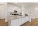 Charming kitchen with granite countertops, a kitchen island and breakfast bar, and white cabinets at 244 Bevis Marks Dr, Fuquay Varina, NC 27526