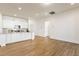 Open-concept kitchen with a large island, white cabinets, and stainless steel appliances, seamlessly connected to the living space at 244 Bevis Marks Dr, Fuquay Varina, NC 27526