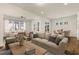 This staged living room has lots of natural light, neutral colors, and is open to a dining area at 244 Bevis Marks Dr, Fuquay Varina, NC 27526