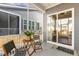 Screened in patio with ceiling fan, a table, and chairs for outdoor relaxation at 244 Bevis Marks Dr, Fuquay Varina, NC 27526