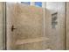 Walk-in shower with tiled surround, built-in bench, and convenient shampoo niche at 244 Bevis Marks Dr, Fuquay Varina, NC 27526