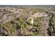 The aerial view highlights the proximity to a golf course as well as the generous trees on the property at 2520 Summit Ln, Creedmoor, NC 27522