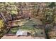 Aerial view of the home with mature trees, a fenced-in yard, and storage shed at 2520 Summit Ln, Creedmoor, NC 27522
