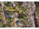 An aerial view reveals a home with a long driveway, nestled among lush trees and a well-maintained yard at 2520 Summit Ln, Creedmoor, NC 27522