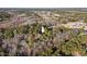 An expansive aerial shot shows the landscape, including trees, fairways and water features, near the location of the home at 2520 Summit Ln, Creedmoor, NC 27522