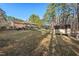 View of the spacious backyard featuring a storage shed and a picnic table at 2520 Summit Ln, Creedmoor, NC 27522