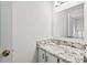 Bathroom features white cabinets, stone countertops, and a framed mirror at 2520 Summit Ln, Creedmoor, NC 27522