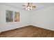 Bright bedroom with hardwood floors and a large window showcasing the beautiful yard at 2520 Summit Ln, Creedmoor, NC 27522