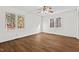 Bedroom features hardwood style floors, ceiling fan, and two windows overlooking wooded backyard at 2520 Summit Ln, Creedmoor, NC 27522