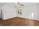 Bedroom features hardwood style floors, ceiling fan, and a window overlooking wooded backyard at 2520 Summit Ln, Creedmoor, NC 27522