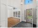 Bright foyer leading to a living area with large windows and beautiful front yard views at 2520 Summit Ln, Creedmoor, NC 27522