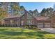 A brick house with a large front lawn features a distinctive window and architectural design at 2520 Summit Ln, Creedmoor, NC 27522