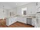 Spacious kitchen features white cabinets, stone countertops, stainless steel appliances and hardwood style floors at 2520 Summit Ln, Creedmoor, NC 27522