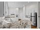 A modern kitchen featuring white cabinets, granite countertops, and stainless steel appliances at 2520 Summit Ln, Creedmoor, NC 27522