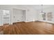 Spacious living room featuring wood floors, neutral walls, and access to a sunroom at 2520 Summit Ln, Creedmoor, NC 27522