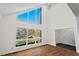 Spacious living room with a large window offering lovely views of the wooded yard at 2520 Summit Ln, Creedmoor, NC 27522