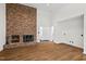 Cozy living room features a brick fireplace and hardwood floors, perfect for relaxing at 2520 Summit Ln, Creedmoor, NC 27522