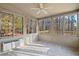 A screened-in porch with multiple windows allowing natural light and a view of the surrounding trees at 2520 Summit Ln, Creedmoor, NC 27522