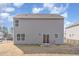 Back exterior view of home featuring a backyard and patio with a metal fence at 2815 E Brookwood Ct, Creedmoor, NC 27522