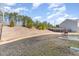 Expansive backyard features a concrete pad and lawn that leads up to a treeline at 2815 E Brookwood Ct, Creedmoor, NC 27522