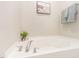 A pristine white bathtub is complemented by fresh greenery and soft gray towels at 2815 E Brookwood Ct, Creedmoor, NC 27522