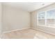 A serene bedroom features plush carpeting, a large window, and neutral colors creating a peaceful retreat at 2815 E Brookwood Ct, Creedmoor, NC 27522
