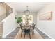 Bright dining room featuring stylish furniture, a modern chandelier, and a large window at 2815 E Brookwood Ct, Creedmoor, NC 27522