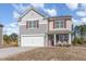 Charming two-story home with a two-car garage, a cozy front porch, and a manicured lawn at 2815 E Brookwood Ct, Creedmoor, NC 27522