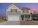Charming two-story home with a two-car garage and a cozy front porch with chairs and a welcoming wreath at 2815 E Brookwood Ct, Creedmoor, NC 27522