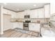 The kitchen is a vision of white cabinets, stainless steel appliances and a beautiful granite countertop at 2815 E Brookwood Ct, Creedmoor, NC 27522