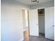 Bedroom includes a ceiling fan, closet, and neutral walls with wood-look flooring at 2918 Kanewood Dr, Durham, NC 27707