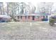 Charming one-story brick home with mature trees and a spacious front yard at 2918 Kanewood Dr, Durham, NC 27707