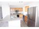 Kitchen with wood cabinets, stainless steel refrigerator, and granite island at 2918 Kanewood Dr, Durham, NC 27707