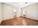 Spacious bedroom featuring hardwood floors, baseboard heaters and two windows providing natural light at 3074 Granville Dr, Raleigh, NC 27609