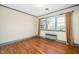 Bedroom boasts hardwood floors and a large window that provides natural light at 3074 Granville Dr, Raleigh, NC 27609
