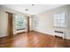 Bedroom featuring hardwood floors, bright windows, and ample natural light at 3074 Granville Dr, Raleigh, NC 27609
