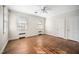 Bright bedroom with original hardwood floors, ceiling fan, two windows and two closets at 3074 Granville Dr, Raleigh, NC 27609