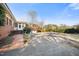 Brick home featuring an attached garage, a long driveway and a brick walkway at 3074 Granville Dr, Raleigh, NC 27609
