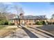 Charming brick home with a well-manicured lawn and mature trees, creating a welcoming curb appeal at 3074 Granville Dr, Raleigh, NC 27609