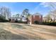 Charming red brick two-story home with attached two-car garage and bright sunroom at 3074 Granville Dr, Raleigh, NC 27609