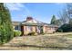Charming brick home with a well-manicured lawn and mature trees, creating a welcoming curb appeal at 3074 Granville Dr, Raleigh, NC 27609