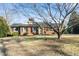 Charming brick home featuring a well-maintained lawn and mature tree in a desirable neighborhood at 3074 Granville Dr, Raleigh, NC 27609
