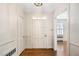 Bright foyer featuring hardwood floors, white trim, and a classic chandelier at 3074 Granville Dr, Raleigh, NC 27609