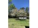 Green lawn in front of a white home with blooming dogwood tree at 3074 Granville Dr, Raleigh, NC 27609