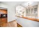 Eat-in kitchen boasts bright cabinets and breakfast bar pass-through to Gathering room with fireplace at 3074 Granville Dr, Raleigh, NC 27609